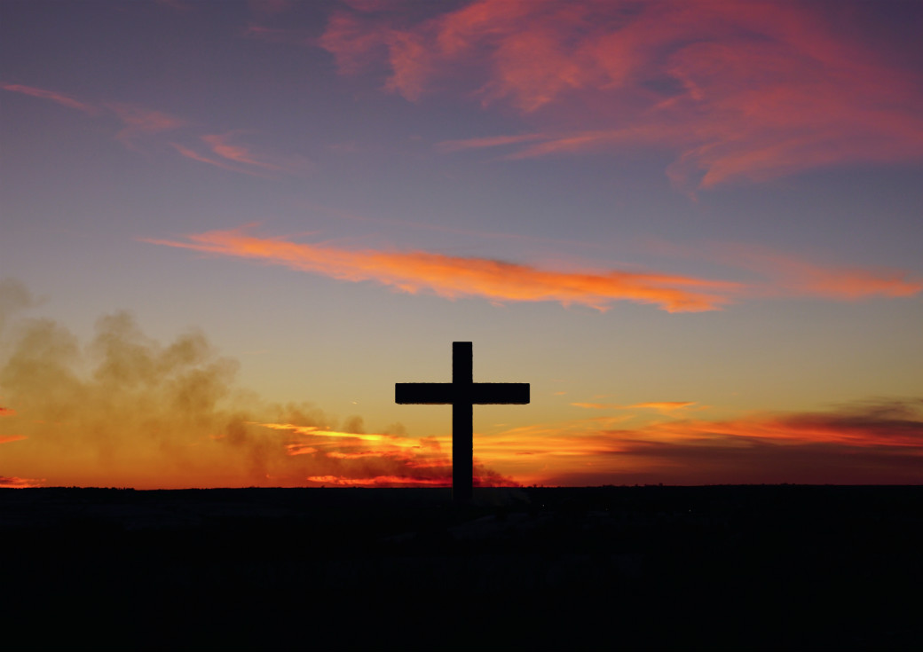 Cross against sunset