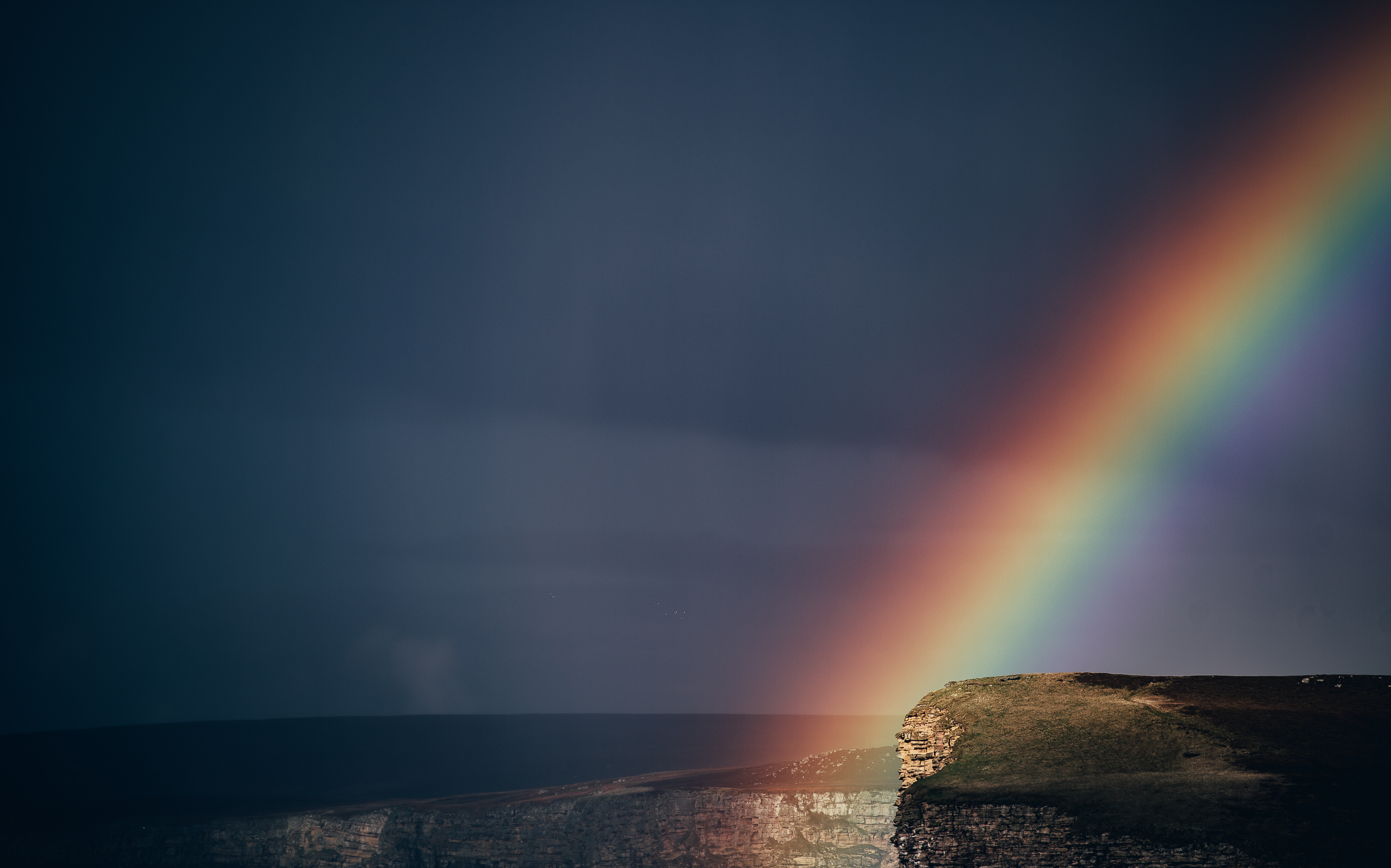 Rainbow over cliffs